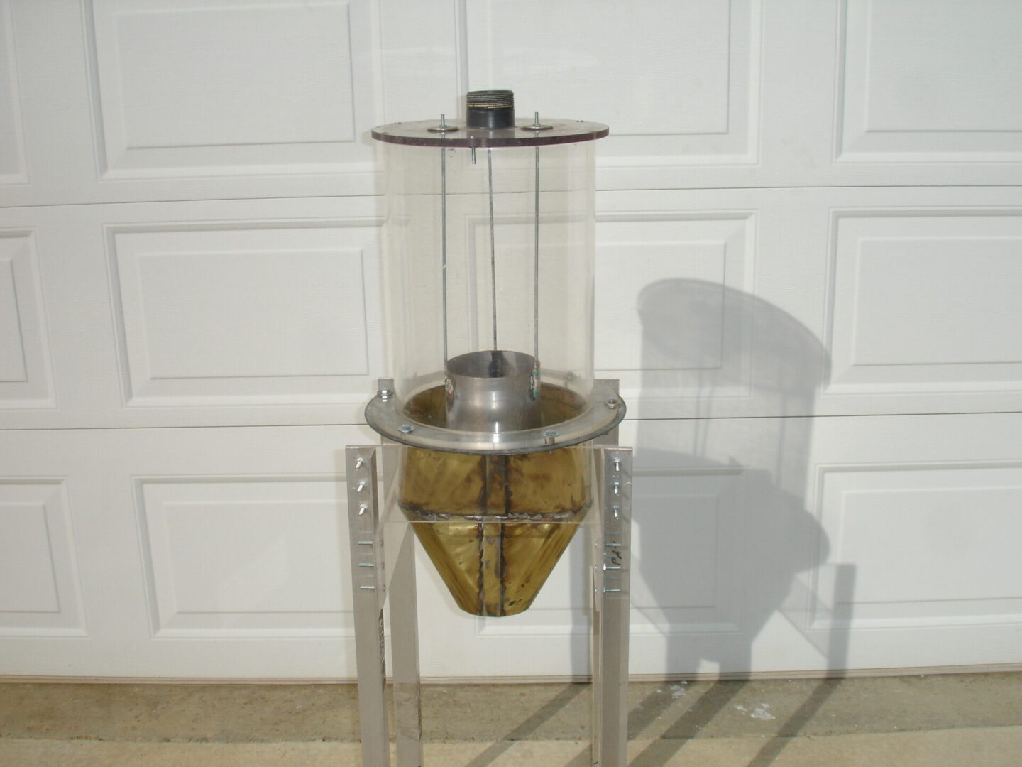 A large glass container on top of a metal stand.