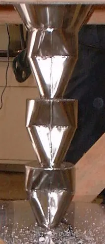 A silver object is standing up on the floor.
