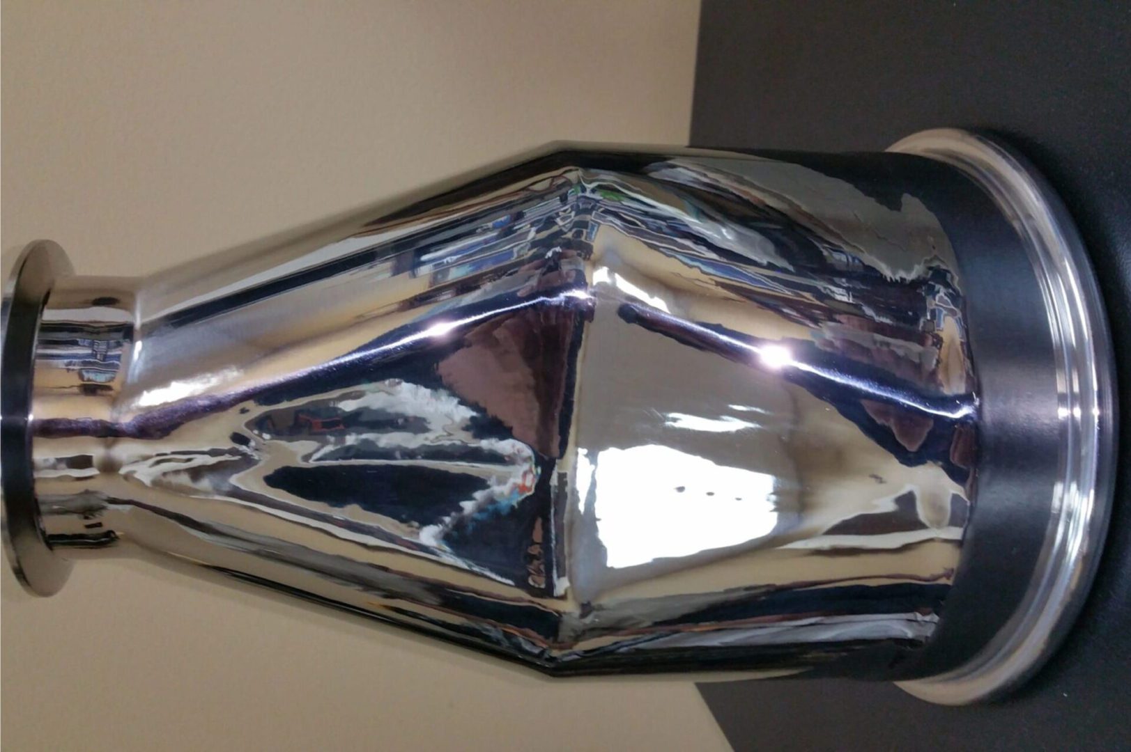 Shiny metallic exhaust or pipe component.