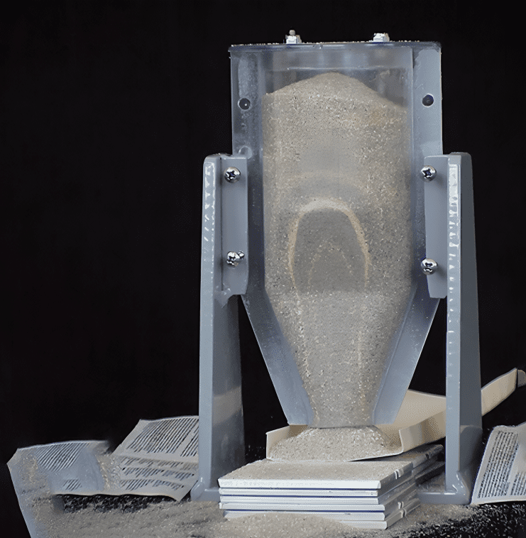 Sand flowing through a transparent funnel apparatus.